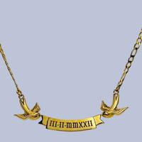 Gold necklace with matching birds holding an engravable banner with a date engraved on the banner